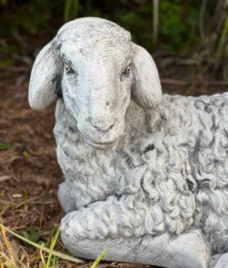 Lying lamb with ears down statue