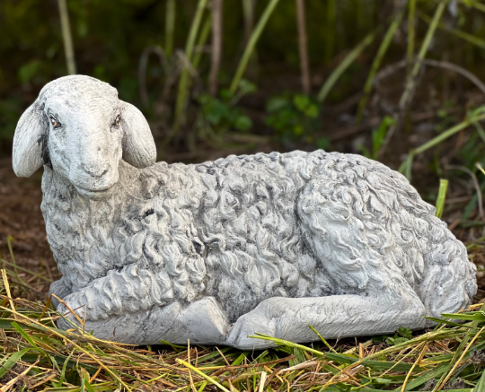Lying lamb with ears down statue