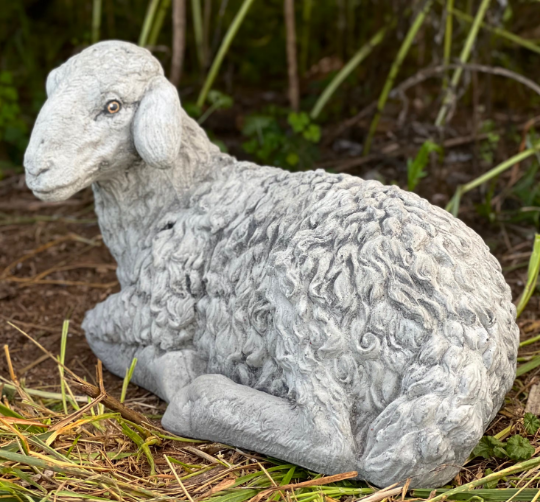 Lying lamb with ears down statue
