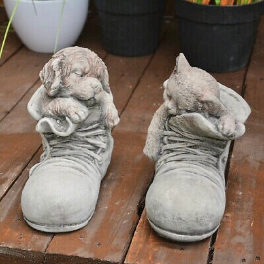 Cat sleeping in boot statue