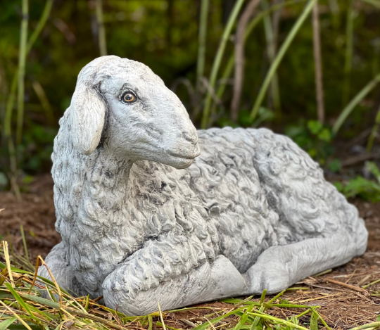 Lying lamb with ears down statue