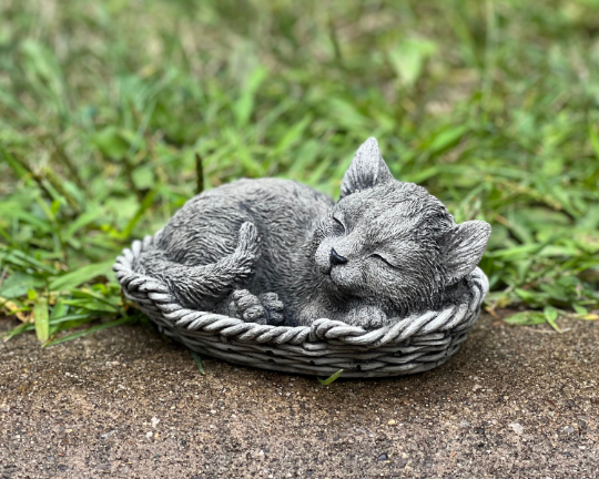 Concrete sleeping cat in basket figure