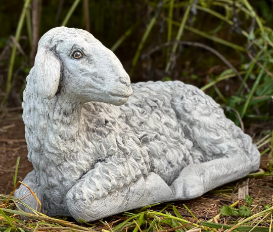 Lying lamb with ears down statue