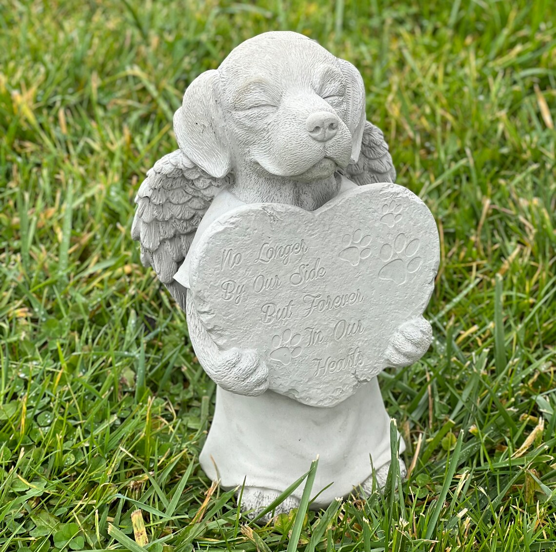 Praying dog with wings statue