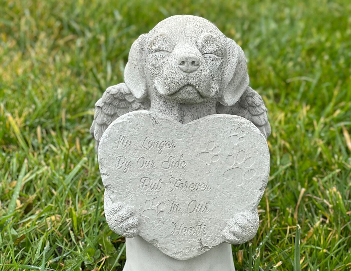 Praying dog with wings statue