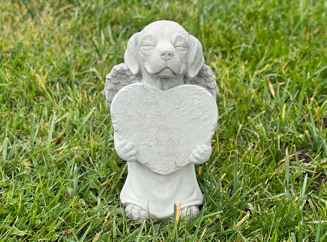 Praying dog with wings statue
