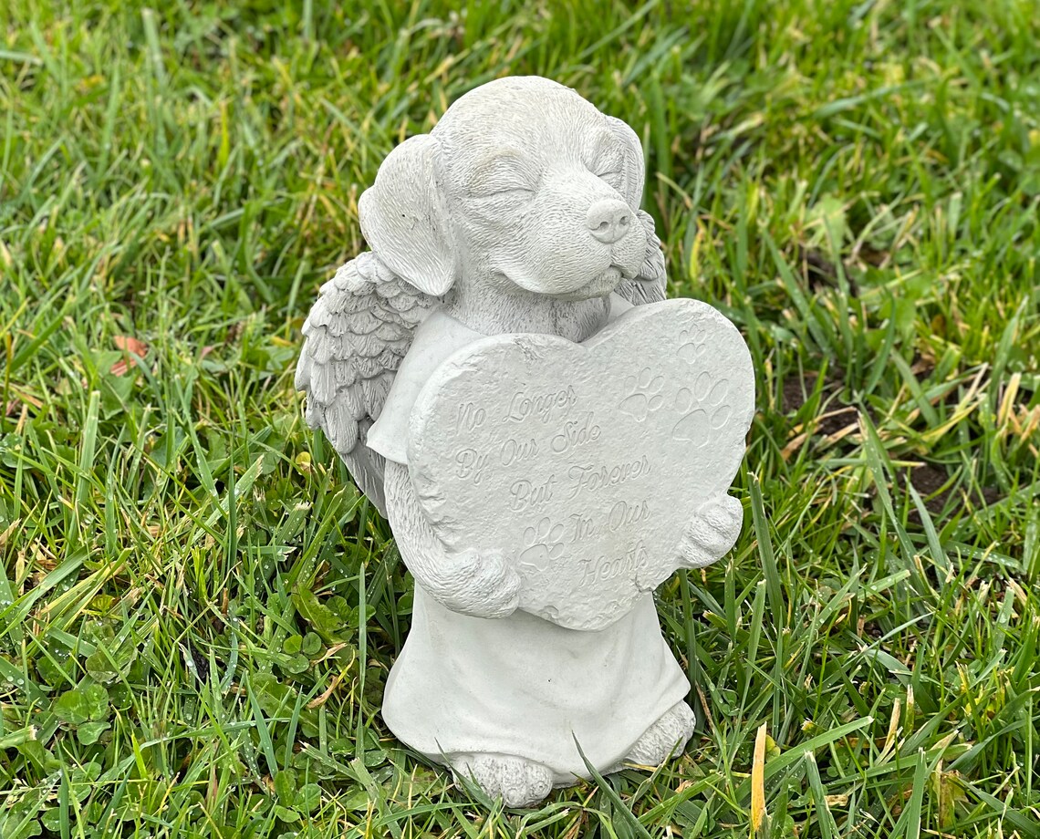 Praying dog with wings statue