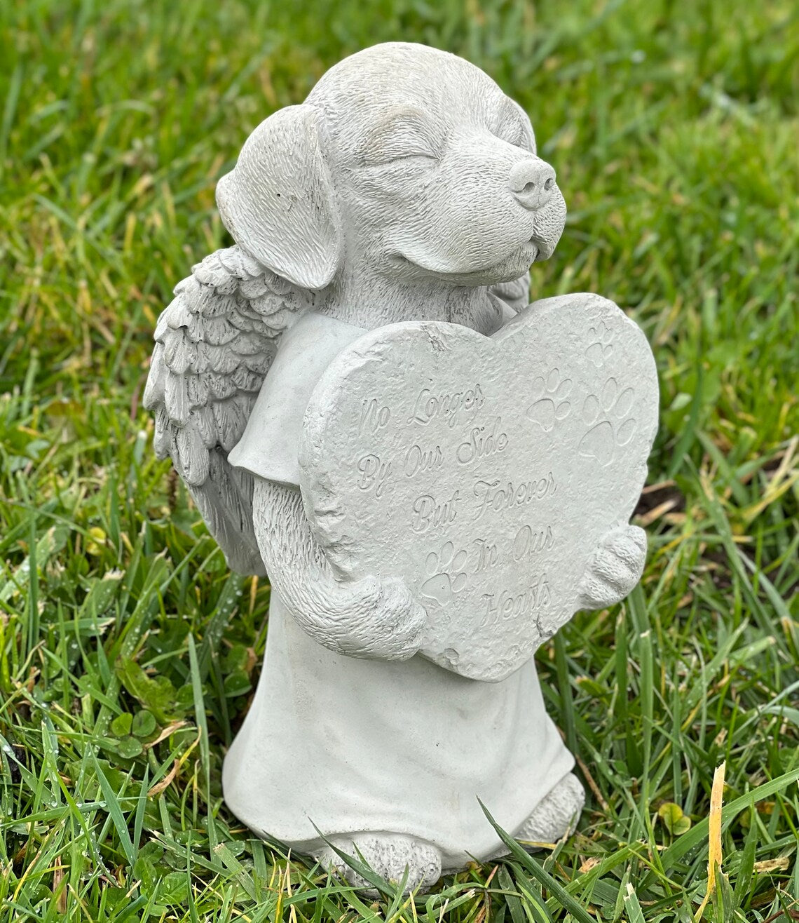 Praying dog with wings statue