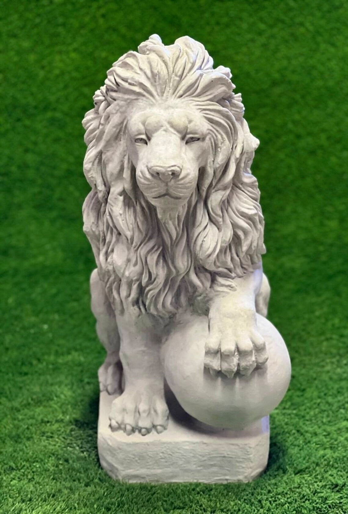 Lion with paw on ball statue
