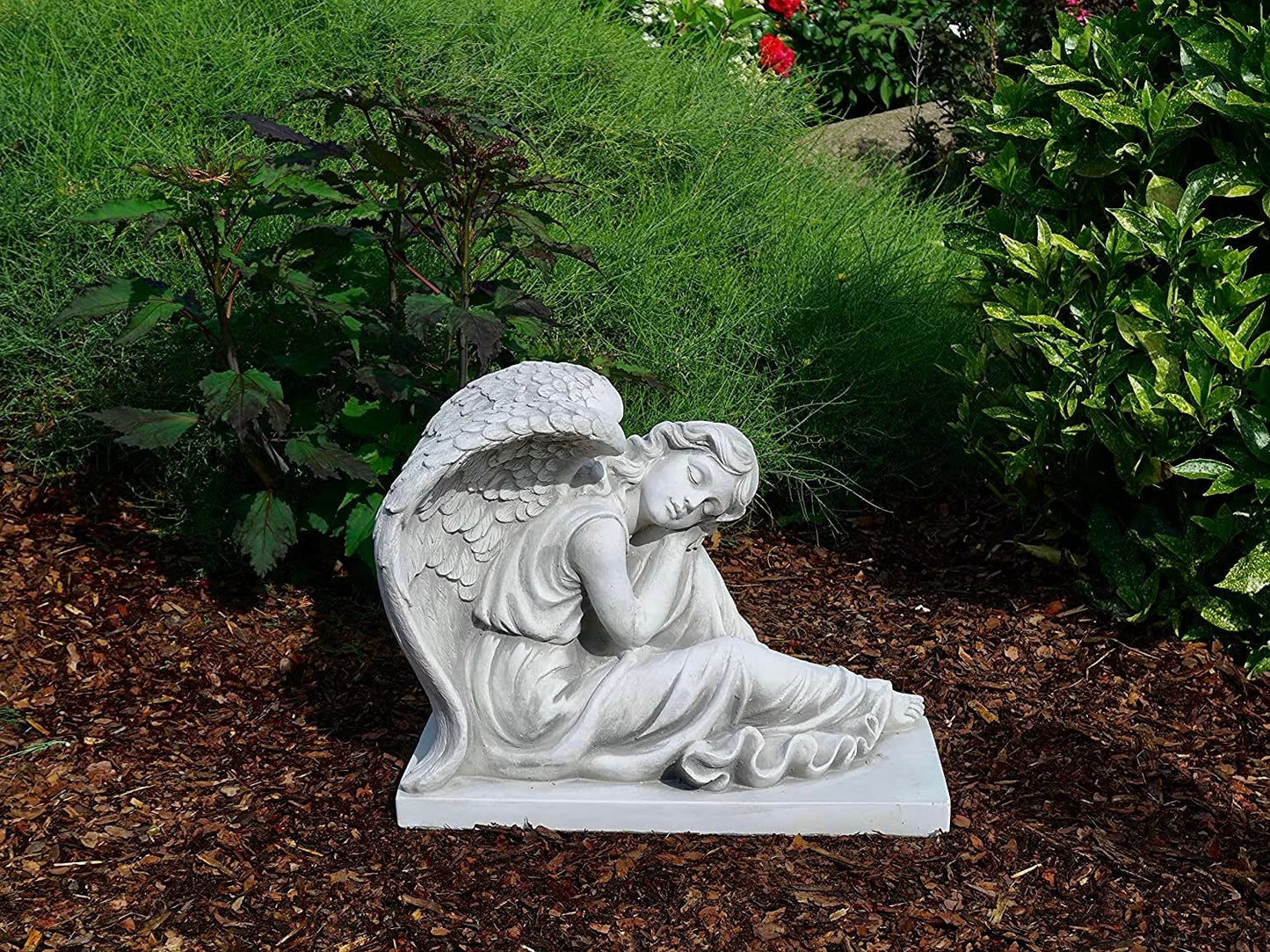 Massive concrete angel on base with foot out