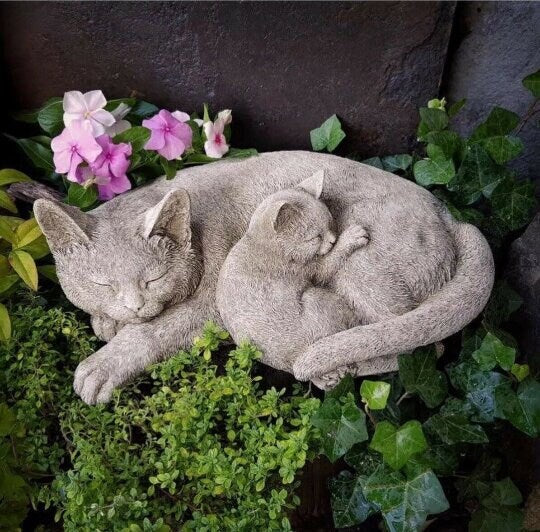 Two curled up sleeping cats statue