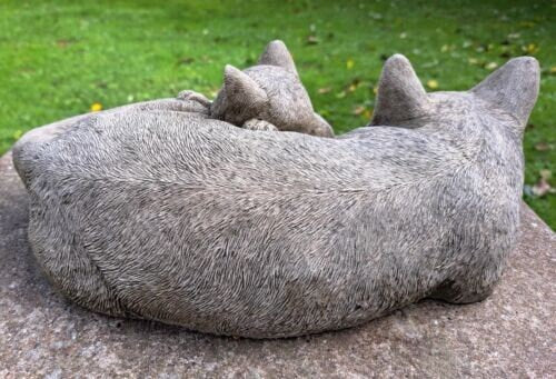 Two curled up sleeping cats statue