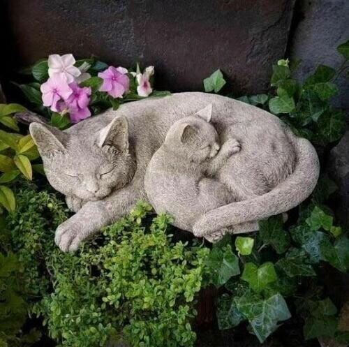 Two curled up sleeping cats statue