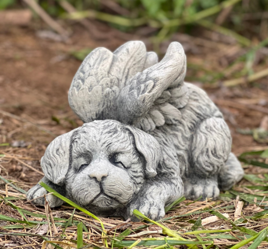 Concrete sleeping dog with wings statue