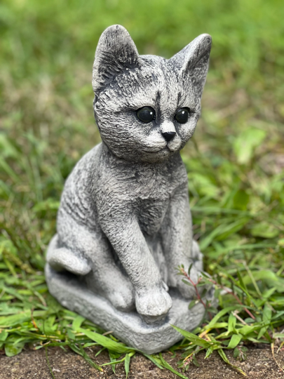 Concrete cat on basement statue