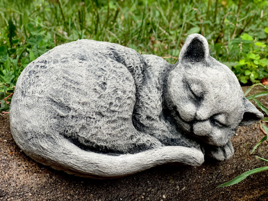 Curled up resting cat figurine