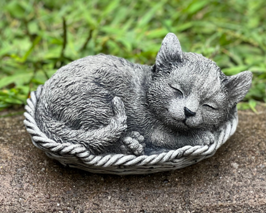 Concrete sleeping cat in basket figure