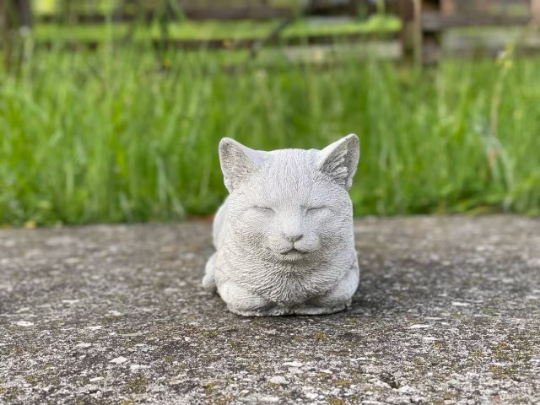 Resting concrete cat statue