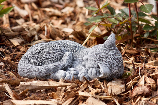 Curled up laying cat statue