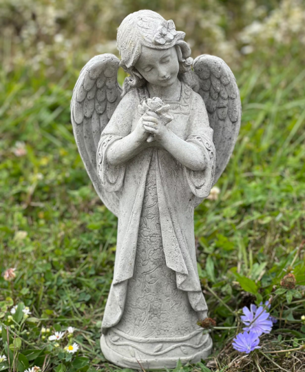 Angel standing holding flowers statue