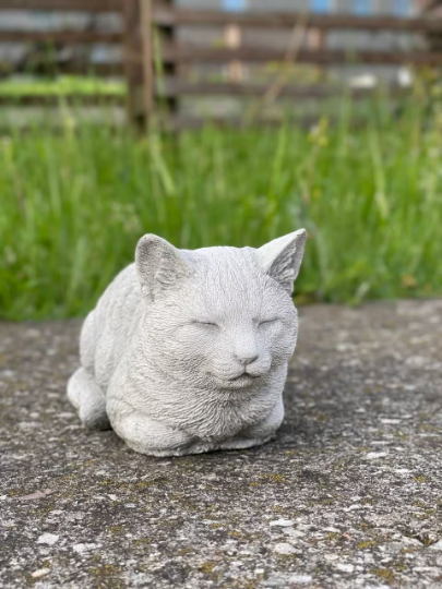 Resting concrete cat statue