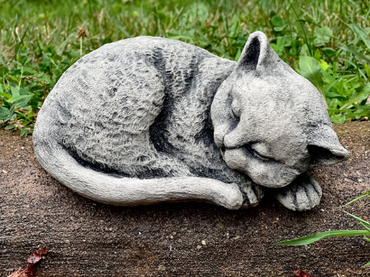 Curled up resting cat figurine