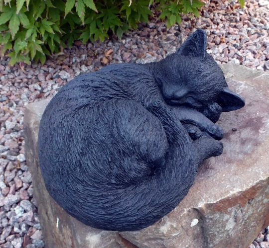 Laying black cat figure