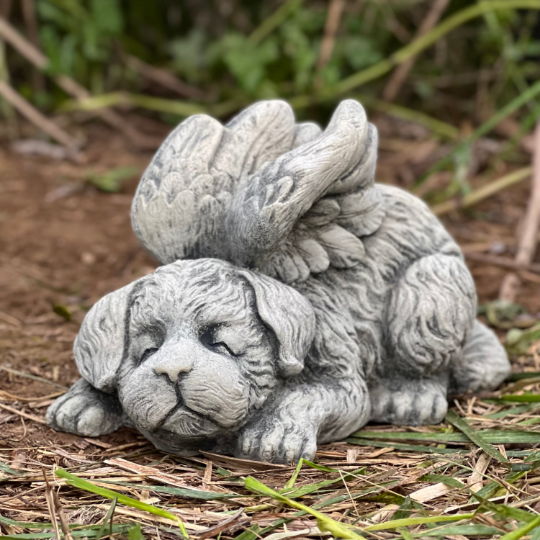 Concrete sleeping dog with wings statue