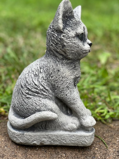 Concrete cat on basement statue