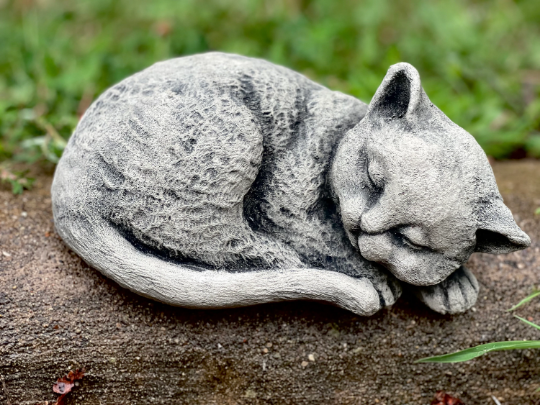 Curled up resting cat figurine