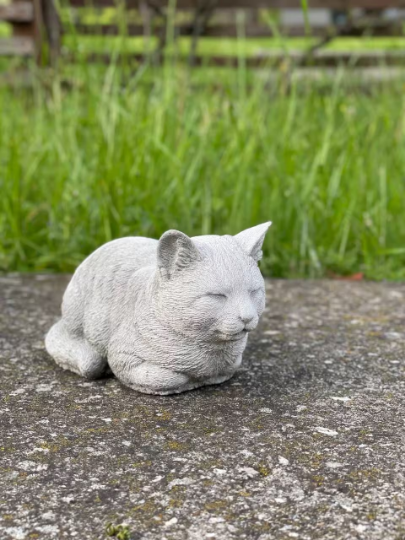 Resting concrete cat statue