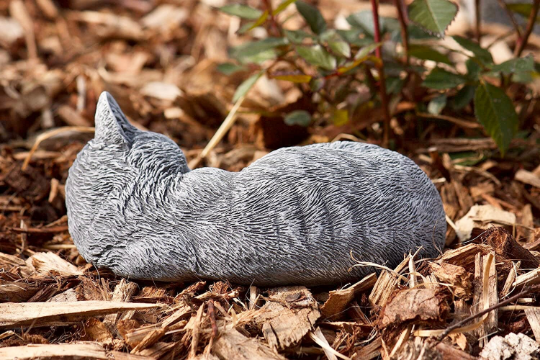 Curled up laying cat statue