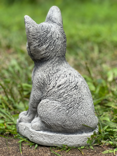 Concrete cat on basement statue