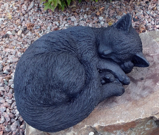 Laying black cat figure