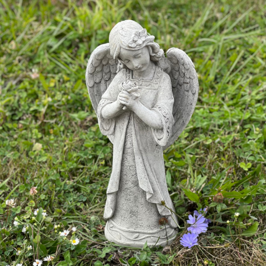 Angel standing holding flowers statue