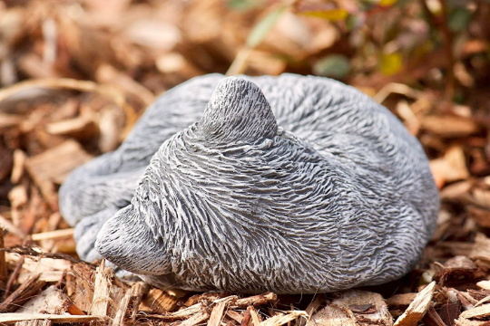 Curled up laying cat statue