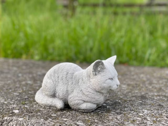 Resting concrete cat statue