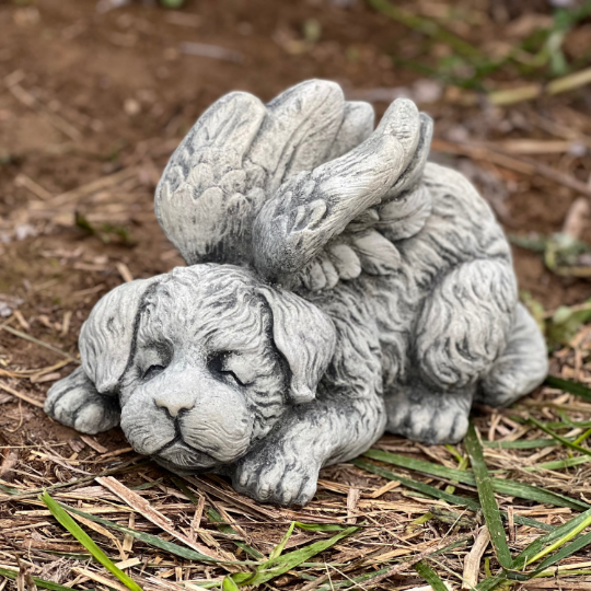 Concrete sleeping dog with wings statue