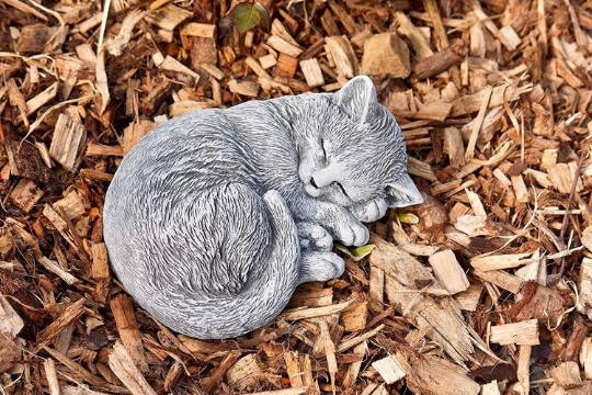 Curled up laying cat statue