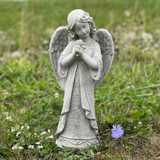 Angel standing holding flowers statue