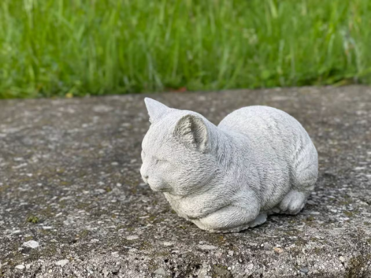 Resting concrete cat statue