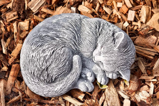 Curled up laying cat statue