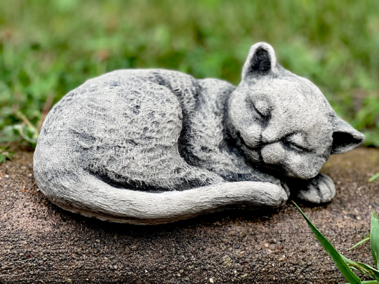 Curled up resting cat figurine