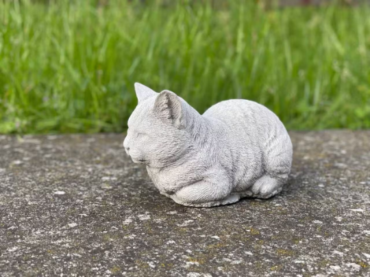 Resting concrete cat statue