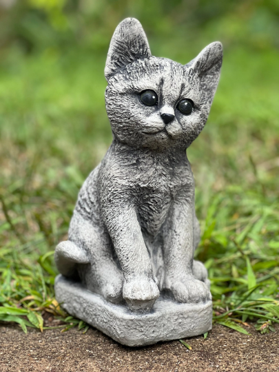 Concrete cat on basement statue