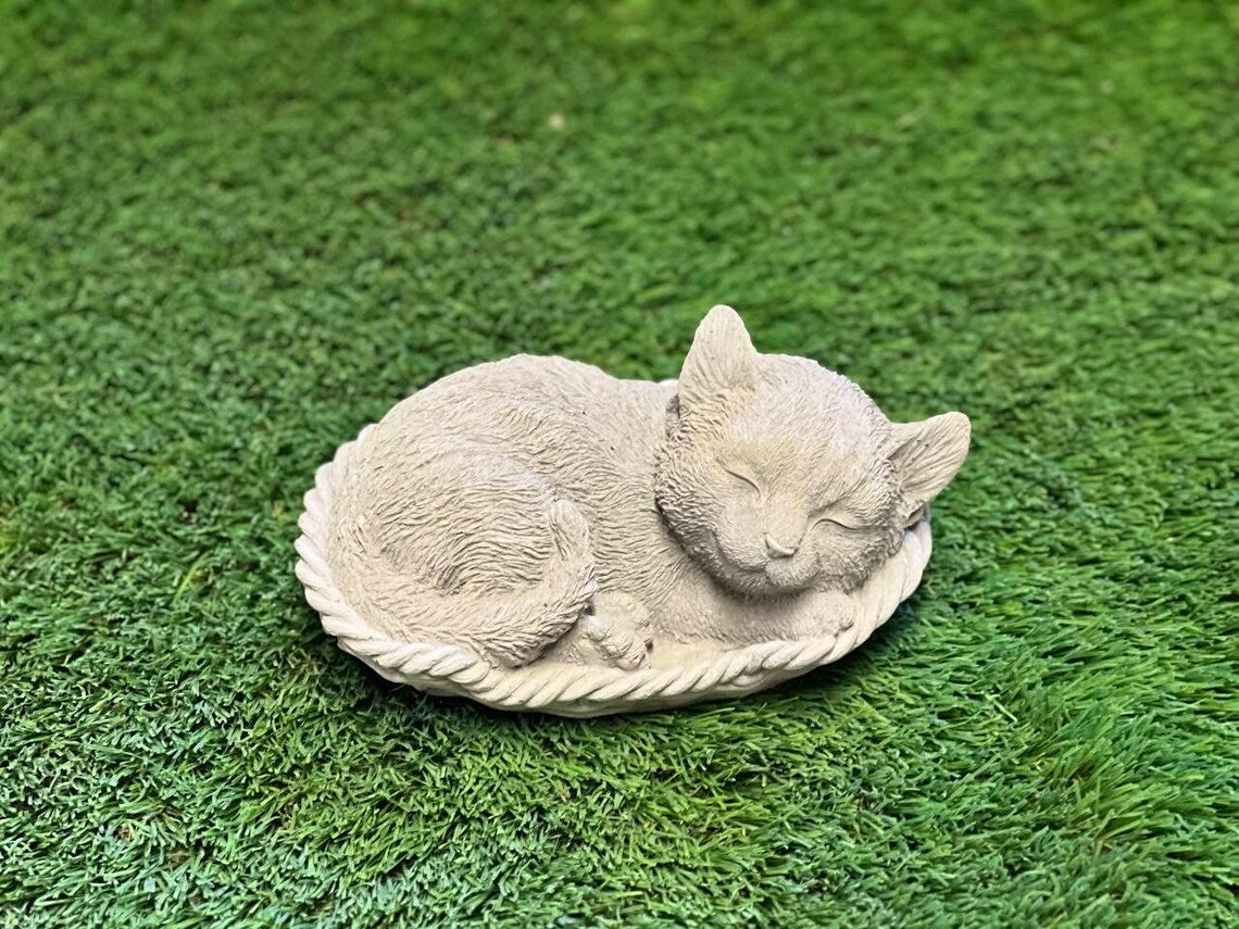 Sleeping cat in basket statue