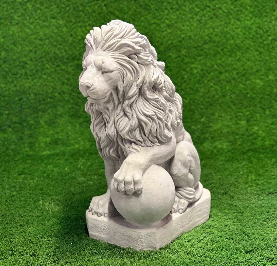 Lion with paw on ball statue