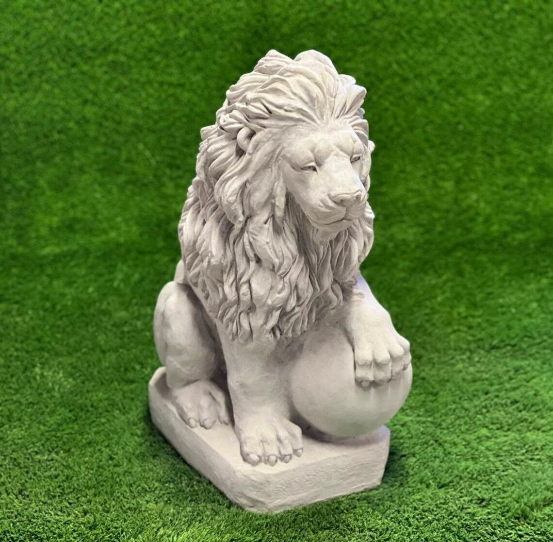 Lion with paw on ball statue