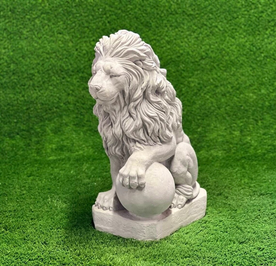 Lion with paw on ball statue