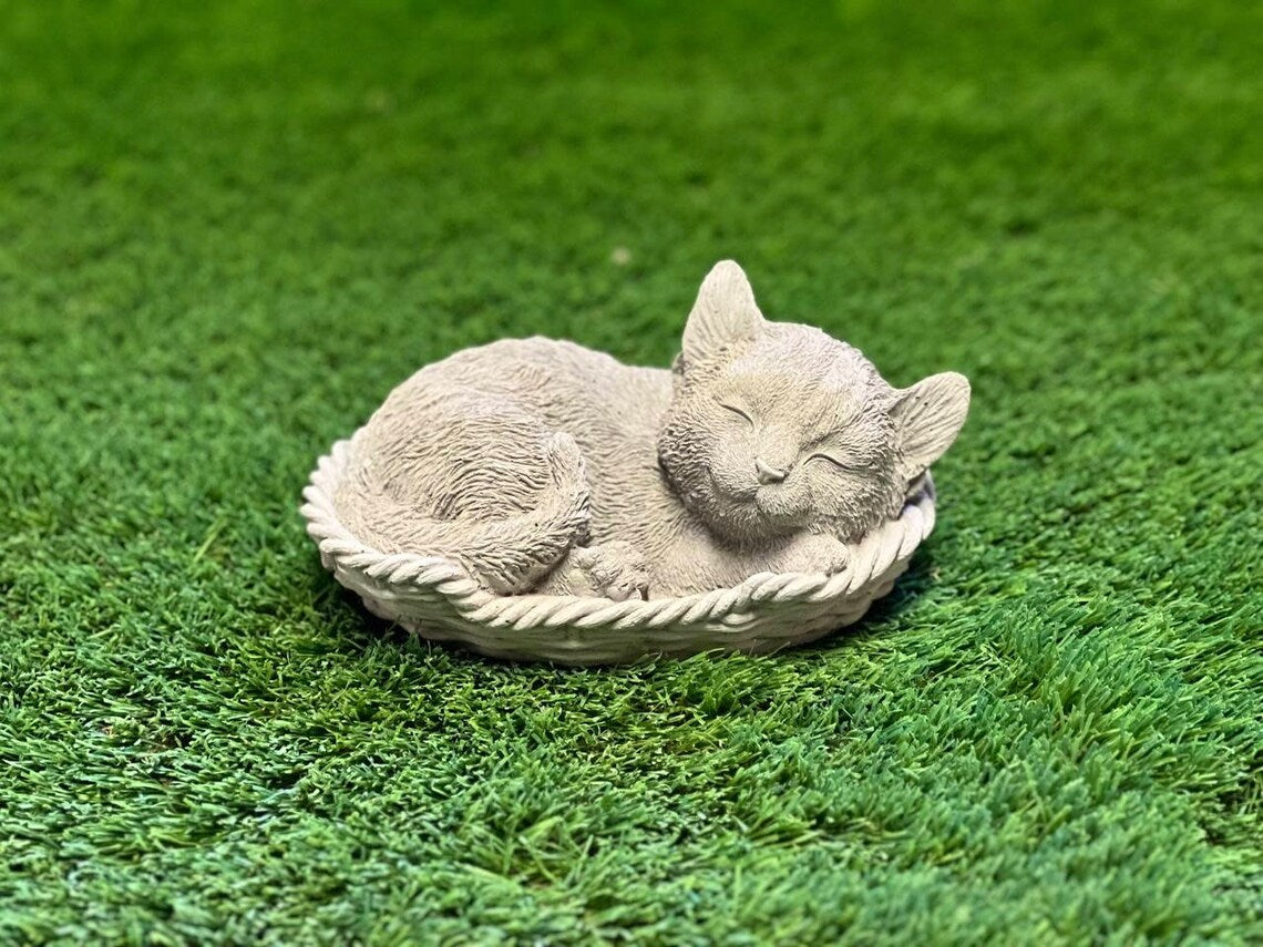 Sleeping cat in basket statue